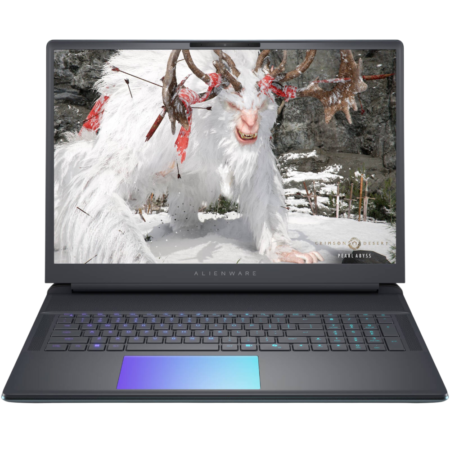 Alienware laptop displaying a snowy scene with a white horned creature on the screen, in a rugged rocky backdrop.