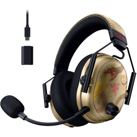Gold and black over-ear gaming headset with an attached microphone and dragon-pattern earcups; includes a USB-C adapter and a small USB dongle.
